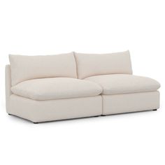 a white couch sitting on top of a white floor