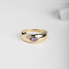 A dome ring made of 14K solid gold with a genuine purple sapphire marquise cut on top. It has a comfort fit, so you can wear it from day to night. This chunky statement ring has a wide and thick band, and it is a great choice for a gift for women with modern style. 100% handcrafted. D E T A I L S ● Metal: 14K solid gold, 14K white gold, 14K rose gold ● Finish: Shinny ● Gemstone: Purple Sapphire, marquise cut ● Gemstone's weight: 0.27 ct R I N G ∙ S I Z I N G For General Reference: ● we use stand Gold Marquise Birthstone Ring With Gemstone, Gold Marquise Birthstone Ring, Gold Marquise Amethyst Gemstone Ring, Gold Amethyst Marquise Ring, Formal Purple Gemstone Signet Ring, Purple Gemstone Signet Ring Gift, Gold Amethyst Ring With Large Stone As Gift, Gold Marquise Amethyst Ring, Gold Marquise Amethyst Ring Fine Jewelry