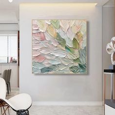 an abstract painting hangs on the wall above a dining room table with chairs in front of it