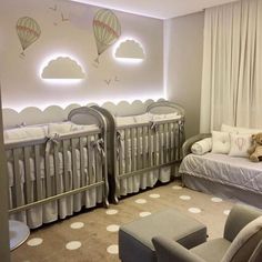 a baby's room with two cribs and a couch