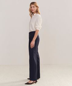 Wool Jones Trouser Navy Our take on classic Italian suiting comes to life in the form of a trouser designed to replace every pant in your wardrobe. With elevated tailoring and all-day comfort, this trouser is an all-purpose pant in disguise. Style with a t-shirt and sneakers or a kitten heel and silk shirt—the outfit options are endless. 95% wool, 5% elastane. Made in China of Italian fabric. Double pleat Italian trouser with relaxed-straight leg. | Jenni Kayne Women's Wool Jones Trouser Size 10 Outfit Options, Italian Suit, Trouser Design, Jenni Kayne, In Disguise, Classic Italian, Italian Fabric, New Tops, Flat Boots