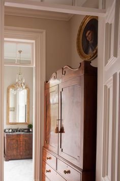 an old fashioned dresser is in the hallway