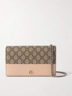 Gucci's wallet is sizable enough to use as a shoulder bag, too - simply attach the silver-tone chain strap and drape it cross-body. It's been made in Italy from monogram coated-canvas trimmed with supple leather and is punctuated with polished 'GG' hardware. Store your phone, cardholder and lip gloss inside. Gucci Luxury Wallet On Chain With Chain Strap, Gucci Leather Wallet On Chain, Classic Gucci Wallet On Chain, Gucci Leather Wallet On Chain For Everyday Use, Classic Gucci Leather Wallet On Chain, Gucci Leather Wallet On Chain For Formal Use, Gucci Leather Wallet On Chain For Formal Occasions, Luxury Beige Wallet On Chain, Formal Beige Leather Wallet On Chain