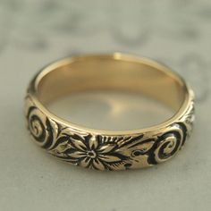 Antiqued Gold Band Antiqued Gold Ring Vintage Style Ring Vintage Style Band Gold Wedding Band Solid 14K Gold Ring Floral Band Crazy Daisy Introducing our new ANTIQUED Gold Bands! Whimsical and absolutely stunning, the embossed floral and swirl pattern encompasses the entire band with elegance and lovely detail. Measuring 5mm wide, it is a hefty 1.5mm thick. This makes it a heavy quality band to pass down for generations. You won't be disappointed! Your ring will be custom made to size just for y Fine Jewelry In Yellow Gold For Marriage, Heirloom Jewelry With Decorative Band, Fine Yellow Gold Jewelry For Marriage, 14k Gold Jewelry With Intricate Design For Marriage, Fine Jewelry Engraved Ring For Wedding, Intricate Yellow Gold Ring For Marriage, Yellow Gold Ring With Intricate Design For Marriage, Intricate Design Yellow Gold Ring For Marriage, Yellow Gold Wedding Rings With Intricate Design