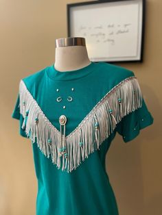 Vintage "Haywood Exclusive" western turquoise fringe shirt, in a women's size medium. Such a beautiful piece with beaded detailing, horse shoe garments and bolo. It does have shoulder pads- definitely from the early 90s late 80s. It's in amazing condition! Message me if you have any questions,. Fringe Blouse, Western Turquoise, Fringe Shirt, Palm Desert, Late 80s, Horse Shoe, Early 90s, Custom Tees, Things I Need