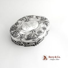 an ornately decorated silver box on a white background with the name berry & co