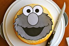 a cookie with an image of sesame street on it and a knife next to it