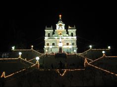 a large building with lights around it at night