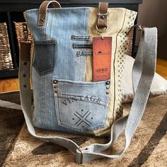 a handbag made out of old jeans with tags on the front and side pockets