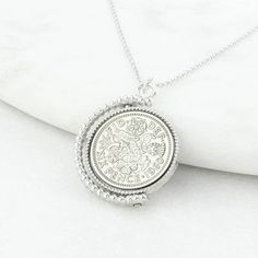 "A lucky sixpence spinner necklace displaying a genuine polished sixpence coin of your chosen date. Featuring a genuine sixpence coin, this vintage inspired necklace makes for a memorable and thoughtful gift for anyone celebrating a birthday or another milestone. The sixpence is traditionally given as a symbol of good luck so would make a fantastic gift for a wedding, birthday or any other special occasion. It is something that can be worn and kept forever. Our Sixpence Spinner Necklace comes pa Classic Charm Necklace With Coin Medallion, Classic Charm Necklaces With Coin Pendant, Classic Charm Necklaces With Coin Medallion Pendant, Classic Medallion Necklace With Coin Pendant As Gift, Classic Coin Necklace For Gifting, Classic Coin Pendant Necklace As Gift, Vintage Coin Necklace With Locket Round Pendant, Vintage Charm Necklace With Coin Pendant, Vintage Coin Necklace With Locket Pendant