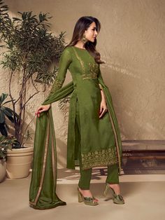 Defined by Malaika Arora's sense of fashion, this mehndi green kurta set is an epitome of grandeur and majestic artwork. Crafted using Zari work and mukaish embroidery, it features a straight top with three-quarter sleeves, a round neck and organza & shantu inner for comfort. The set includes a pair of cotton trousers and an organza dupatta with exquisite floral Zari machine weave yoke/border embroidery and taping. TOP: Organza, TOP INNER: Shantun, BOTTOM: Cotton, DUPATTA: Organza, Dry Clean Mehndi Green Suit, Mukaish Embroidery, Western Kurtis, Yoke Design, Malaika Arora, Organza Top, A Line Kurta, Cotton Dupatta, Border Embroidery