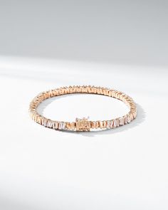 Crafted in 18-karat gold, this tennis bracelet incorporates our beloved baguette diamonds unevenly set while interchanging them with sections of gold all the way around. We love this piece for its seamless design and everyday wearability. The perfect baguette tennis bracelet to instantly elevate any outfit, casual or formal. Details 18k yellow gold, rose gold or white gold 2.00 carats of white diamond baguettes Bracelet measures 7" inches in length Box clasp with safety lock fastening 5mm width Timeless Everyday Luxury Diamond Bracelet With Baguette Diamonds, Modern Tennis Bracelet With Baguette Diamonds And Cubic Zirconia, Luxury Rose Gold Tennis Bracelet With Baguette Diamonds, Fine Jewelry Rose Gold Diamond Bracelet With Baguette Cut, Rose Gold Baguette Cut Diamond Bracelet, Elegant Rose Gold Baguette Diamond Tennis Bracelet, Luxury Rose Gold Baguette Cut Bracelets, Anniversary Tennis Bracelet With Baguette Diamonds, Baguette Diamond Bangle Tennis Bracelet