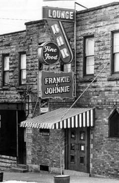 an old black and white photo of a store front