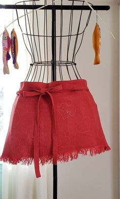 a red skirt hanging on a clothes rack