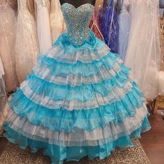 Blue Embellished Ball Gown With Fitted Bodice, Princess Style Blue Dress For Debutante Ball, Blue Princess Ball Gown With Fitted Bodice, Blue Floor-length Quinceanera Dress For Debutante Ball, Blue Floor-length Quinceanera Dress, Blue Floor-length Quinceanera Dress For Party, Blue Gown For Quinceanera And Prom Season, Blue Floor-length Quinceanera Party Dress, Blue Ruffled Dress For Debutante Ball