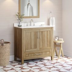 a bathroom with a sink, mirror and basket on the floor in front of it