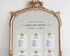 an ornate gold framed mirror with seating cards attached to the front and back of it