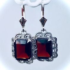 These are Victorian reproduction earrings in sterling silver set with stunning Natural wine red garnet gemstones. Each festoon earring is 28mm x 13mm in dimension with post-backs. The earrings are 1 and 1/4 inches long with lever-backs (28mm long). Each gemstone is 10mm x 8mm and are 3.8ct each. The earrings closures are a choice of ear wires, deco-posts, or lever-backs. Most popular for this earring are the posts-backs and the lever-back style for comfortable wear, and to prevent loss. Victorian Filigree, Silver Shorts, Antique Filigree, Filigree Jewelry, Natural Wine, Rhaenyra Targaryen, Garnet Earrings, Jewelry Antique, Art Deco Art