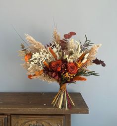 a bouquet of flowers sitting on top of a wooden table