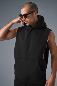 Stay cozy without sacrificing style in the Renown Sleeveless Hoodie. It has deep armholes, a kangaroo pocket, and a laid-back cut. And wait till you feel the Alo signature Renown fabric—it's smooth on the outside, a little fleecy on the side, and heavyweight for a just-right drape. Add shorts and you’re covered from the gym to the street. Black Top With Kangaroo Pocket For Streetwear, Black Tops With Kangaroo Pocket For Streetwear, Sleeveless Vest With Side Pockets For Streetwear, Urban Vest With Side Pockets, Urban Style Sleeveless Vest With Side Pockets, Black Sleeveless Vest With Side Pockets, Black Sleeveless Relaxed Fit Activewear, Alo Yoga Black Top For Loungewear, Alo Yoga Athleisure Streetwear Tops