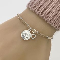 "Pictures are enlarged to show details of the item. Please refer to original size and measurements in the following description  The bracelet features sterling silver Saint Benedict medal and tiny heart charm. Details: - Material metal: 925 sterling silver - Saint Benedict charm measures approx 12mm - Adjustable bracelet length from 6.5\" to 7.5\". Please leave a note if you prefer different length. PERSONALIZATION: Add an initial charm here: https://etsy.me/2vqe7pr Add a sterling silver cubic zirconia birthstone here: https://etsy.me/2O4TBFR Add a Swarovski crystal birthstone here: https://etsy.me/2zSgJyA ENTER OUR SHOP HERE for more jewellery : https://etsy.me/2yqbxk6 STORE POLICY: To make sure you're always 100% satisfied please read our store policies here prior to ordering:  https://e St Benedict Bracelet, Saint Benedict Medal, Custom Rosary, Benedict Medal, Christian Bracelets, Adjustable Bangle Bracelet, Saint Benedict, St Benedict, Rosary Bracelet