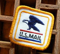 a small patch with the word u s mail on it and a bird in flight