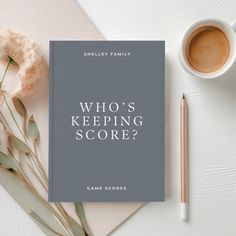 a book with the title who's keeping score? next to a cup of coffee