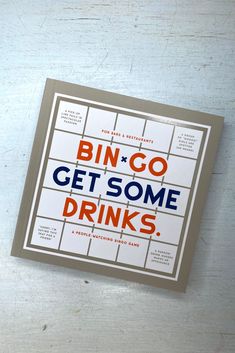 a book that is sitting on top of a wooden table with the words bingo get some drinks