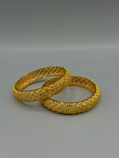 Embrace the allure of South Asian craftsmanship with our exquisite Gold-Plated Bangles. Inspired by the intricate designs of Indian, Pakistani, and Nepali jewellery, these bangles radiate elegance and charm. The smooth gold plating adds a touch of luxury to your ensemble, making them a versatile accessory for any occasion. Whether you're attending a wedding, celebrating a festival, or simply want to elevate your everyday style, these bangles effortlessly enhance your look with their timeless bea Nepali Jewelry Gold, South Indian Gold Jewellery, Nepali Jewelry, Rani Haar, Gold Plated Bangles, Ball Chain Necklace, South Asian, Intricate Designs, Contemporary Fashion