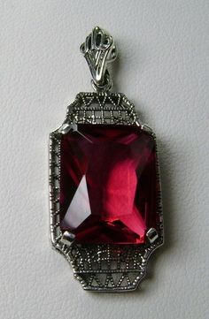 "Simulated Red Ruby Pendant Lantern Design#P13 Custom Made About 6 months ago I found a lovely Art Deco brooch and fell in love with the design. Fashioned in the design of the brooch, I now offer this lovely Antique reproduction pendant in sterling silver (matching 18ct earrings also available for sale). The flawless Simulated 9ct red/pink ruby is 15mm long (just over 9/16\") and 12mm in width (1/2th\"). The pendant is 1 3/8th inches long, it is 9/16th\" wide. The bail opening is 3.5mm wide and Classic Red Ruby Jewelry, Classic Red Birthstone Jewelry, Classic Evening Ruby Jewelry, Classic Red Gemstone Jewelry, Victorian Ruby Necklace For Formal Occasions, Red Victorian Necklace For Anniversary, Classic Red Jewelry As A Gift, Classic Red Pendant Necklace, Classic Ruby Necklaces For Formal Occasions