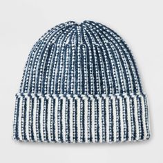 the blue and white striped beanie is shown on a white background with black dots