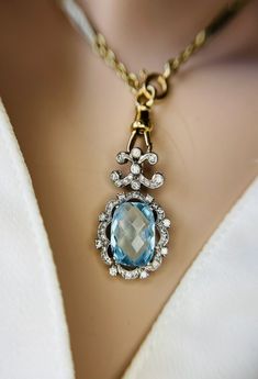 Timeless Topaz Jewelry Gift, Luxury Blue Diamond-cut Necklace, Timeless Blue Jewelry With Diamond Accents, Timeless Blue Cubic Zirconia Jewelry, Elegant Blue Hallmarked Necklace, Yellow Gold Aquamarine Pendant Jewelry, Luxury White Gold Blue Topaz Necklace, Blue Diamond Briolette Necklace, Luxury Blue Topaz Jewelry