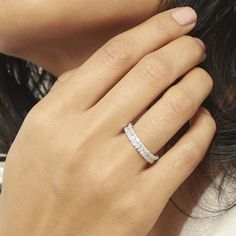 a woman's hand with a diamond ring on her finger