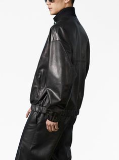 leather bomber jacket from Gucci featuring black, lambskin, embossed logo to the rear, ribbed band collar, front zip fastening, long sleeves, two side zip-fastening pockets, elasticated cuffs and elasticated hem. This item is in size 48 and the color is Leather Jacket With Ribbed Cuffs For Streetwear, Luxury Leather Jacket With Zipper For Streetwear, Gucci Long Sleeve Track Jacket For Fall, Gucci Black Outerwear For Streetwear, Leather Jacket With Zip Cuffs For Streetwear, Gucci Luxury Leather Jacket For Winter, Classic Black Gucci Outerwear, Gucci Fall Streetwear Outerwear, Gucci Leather Jacket Luxury