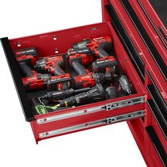 a red tool box filled with tools on top of a white background and black drawers