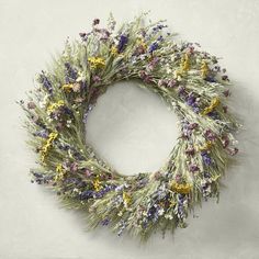 a wreath made out of dried lavender and yellow flowers