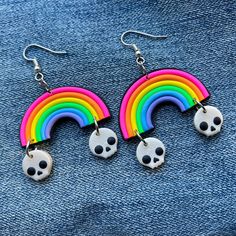 "These bright rainbow earrings have little pearlescent skulls dangling from each side like clouds! ATTENTION! as these are handmade and my colors are custom blended, there may be slight variations in colors depending on batch. Handmade from polymer clay. Dimensions (not including hook) 1.5\" x 1.5\" All clay components are baked together with a strong bonding agent, they will withstand everyday wear with no issue. As with any handmade jewelry, please treat with care. Polymer clay jewelry can be Spooky Jewelry, Creepy Earrings, Trippy Visuals, Candy Jewelry, Funky Earrings, Goth Jewelry, Cute Pastel, Bright Rainbow, Rainbow Earrings