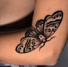 a black and white tattoo with a butterfly on it's side ribcage