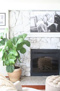 a living room with a fire place and pictures on the wall above it's mantle