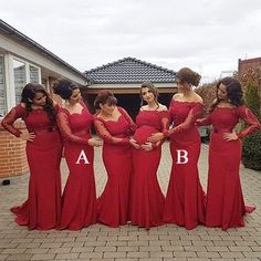 a group of women in red dresses posing for a photo outside the house with their hands on their hipss