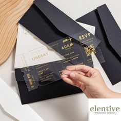 a person is holding some black and gold ticket stuissing from their envelopes