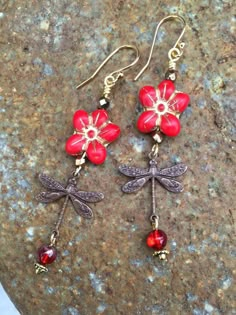 "Adorable orange red Czech glass \"Forget Me Not\" flowers wire wrapped with little translucent red rounds and vintage bronze stamped dragonfly charms. Matte opaque red 13 x 14 mm Czech glass flower has golden bronze Picasso glaze and is wire wrapped in gold plate. Pretty little 5 mm translucent red Czech glass ball with metallic gold finish dangles on the end. Lightweight earrings hang from 14k gold plated ear wires and measure 2 7/8\" long." Red Whimsical Nickel-free Earrings, Whimsical Red Nickel-free Earrings, Whimsical Red Jewelry With Matching Earrings, Vintage Red Copper Earrings, Whimsical Handmade Red Earrings, Red Vintage Copper Jewelry, Vintage Red Copper Jewelry, Whimsical Red Flower Jewelry, Red Bohemian Soldered Earrings