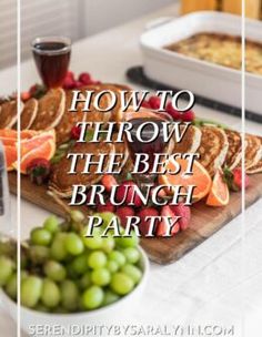 the best brunch party food is served on a cutting board with grapes and oranges