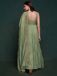 Introducing our amazing sea green georgette mehendi wear gown with a heavy dupatta! This beautiful green gown is perfect for all your festive occasions, from Mehendi ceremonies to festivals and special events. The gown is made of high-quality georgette fabric and comes fully stitched in sizes ranging from XS to XXL, ensuring a perfect fit for everyone.
This stunning gown includes a similar color georgette dupatta with intricate sequin work, thread embroidery, and designer lace work. This adds a Green Maxi Length Traditional Wear With Cutdana, Green Maxi Length Choli With Dupatta, Green Georgette Gown With Cutdana, Green Georgette Gown With Cutdana Detail, Green Cutdana Georgette Gown, Green Anarkali Sharara For Reception, Green Sharara For Reception, Pista Green Georgette Anarkali Set With Traditional Drape, Pista Green Floor-length Dupatta With Gota Work