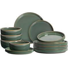 a set of green dishes with gold rims