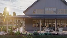 an artist's rendering of a house with patio and covered porch area in the evening