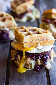 a waffle sandwich is sitting on a wooden table