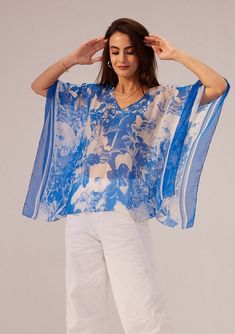 Reena Sharma | Azure Blue Kaftan Top | INDIASPOPUP.COM Flowy V-neck Tops For Beach Cover-up, Relaxed Fit Tops With Kimono Sleeves For Spring, Spring Tops With Kimono Sleeves And Relaxed Fit, Spring Tops With Relaxed Fit And Kimono Sleeves, Chic Short Sleeve Spring Kaftan, Floral Print V-neck Beachwear Top, Chic V-neck Printed Kaftan, Elegant Printed Tops For Vacation, Casual Tops With Kimono Sleeves For Vacation