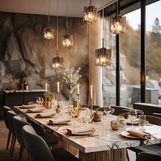 a dining room table is set with candles and place settings in front of a large window