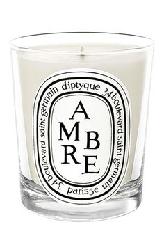 a small glass candle with the words po mandere on it's side